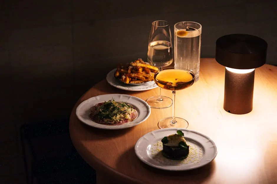 Sophisticated dining setup with gourmet hearth-cooked dishes and wine at Olive & Ember